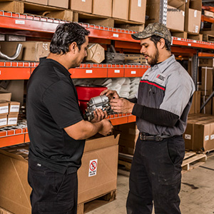 A parts specialist discussing a forklift part with a customer