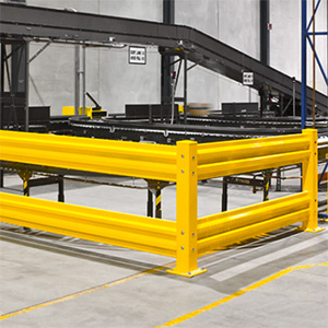 Bright yellow safety railing protecting conveyor belts