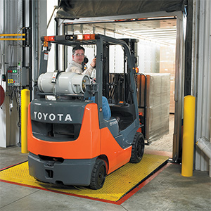 Toyota IC Cushion Forklift backing out of a trailer