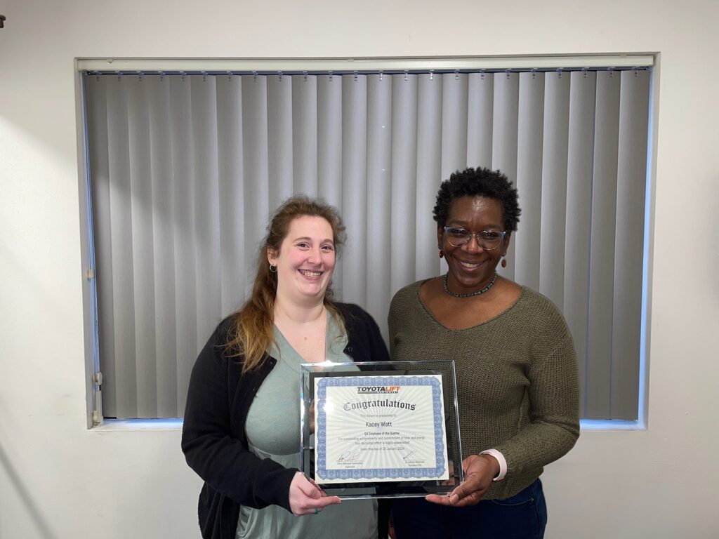 Kacey (left) receives the Q4 2023 award from Leisa (right). 